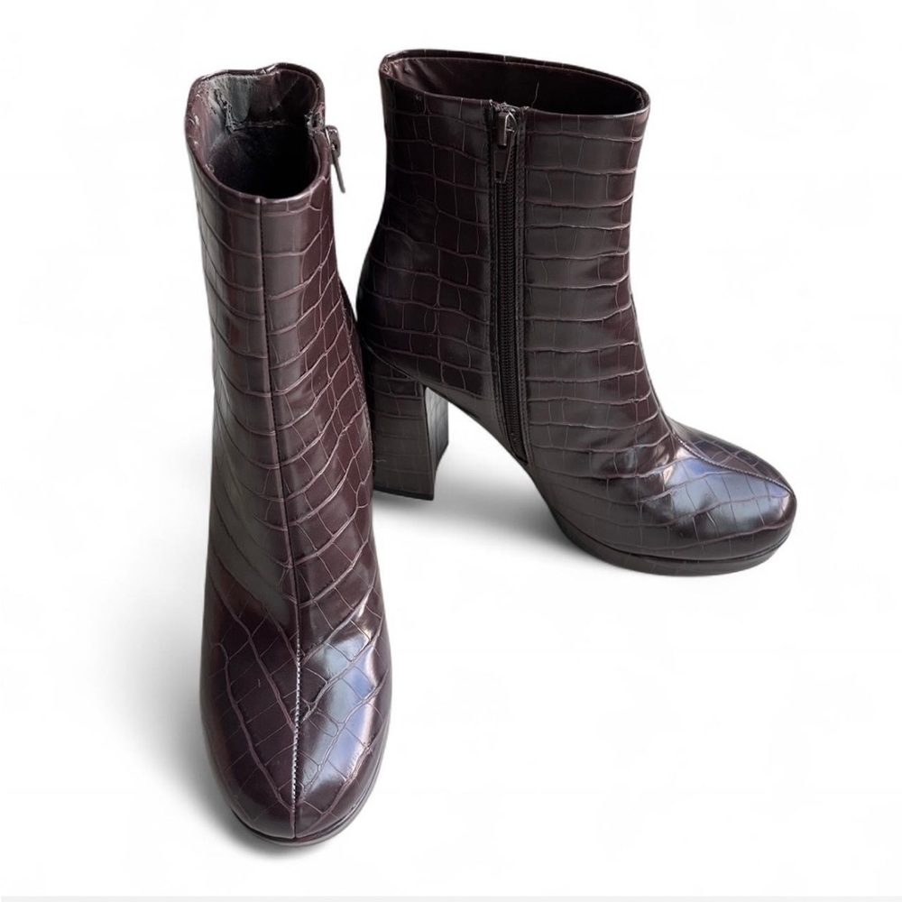 Brown leather ankle boots with zipper closure.